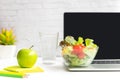 Healthy snack with working in office.  Green apple and fresh salad with water for diet Health Plan with laptop on white dress work Royalty Free Stock Photo