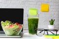 Healthy snack with working in office. Green apple and fresh water for diet Health Planning, laptop work background.