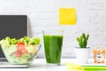 Healthy snack with working in office. Green apple and fresh water for diet Health Planning, laptop work background. Royalty Free Stock Photo