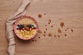 Healthy snacks in bowl: yoghurt, oat flakes, fruit, chia and goji seeds