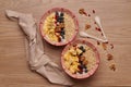 Healthy snacks in bowl: yoghurt, oat flakes, fruit, chia and goji seeds