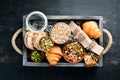 Healthy snacks in a wooden box. oatmeal bars, croissant, raisins, nuts. Top view. Royalty Free Stock Photo