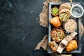 Healthy snacks in a wooden box. oatmeal bars, croissant, raisins, nuts. Top view. Royalty Free Stock Photo