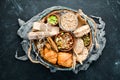 Healthy snacks in a wooden box. oatmeal bars, croissant, raisins, nuts. Top view. Royalty Free Stock Photo