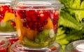 Healthy snak, dessert, colorful fresh fruits and berries cutted in pieces and served in plastic glass, street food Royalty Free Stock Photo