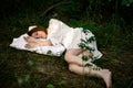 Healthy sound sleep. Rest, relaxation in the forest. Woman sleeps on a pillow on a green glade in the forest