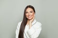 Healthy spa woman with clear skin and dark long straight hair on white background. Young female model smiling. Haircare and facial Royalty Free Stock Photo