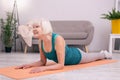 Pleasant senior woman exercising muscles of her neck Royalty Free Stock Photo