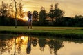 Healthy Sport. Asian Sporty woman golfer player chips and swing golf on the green sunset evening time Royalty Free Stock Photo