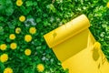 Yellow yoga mat on grass with dandelions