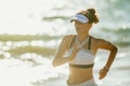 Healthy sports woman on seashore in evening jogging Royalty Free Stock Photo