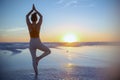 Healthy sports woman in sport clothes at beach at sundown