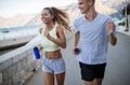 Healthy sporty lifestyle. Happy fit people friends exercising and running outdoor Royalty Free Stock Photo