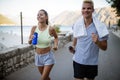 Healthy sporty lifestyle. Happy fit people friends exercising and running outdoor Royalty Free Stock Photo