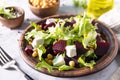 Healthy spring salad beet with spinach, cheese feta and chickpeas on a marble tabletop