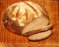 Healthy stone baked organic sourdough bread on an old wooden board