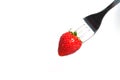 Healthy Strawberry impale with stanley fork on white isolated background