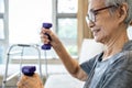 Healthy and strong in old age,Happy smiling asian senior woman working out with heavy dumbbells,lifting dumbbell weight for Royalty Free Stock Photo