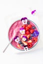 Healthy summer berry smoothie bowl with flowers and chia seed Royalty Free Stock Photo