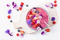 Healthy summer berry smoothie bowl with flowers and chia seed Royalty Free Stock Photo