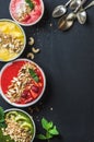 Healthy summer breakfast concept. Colorful fruit smoothie bowls with nuts, oat granola and mint leaves, five silver Royalty Free Stock Photo