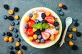 Healthy summer breakfast concept, fruit salad in carved watermelon. Watermelon bowl with yogurt, chia seeds, fresh berries Royalty Free Stock Photo