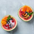 Healthy summer breakfast with fruit salad and yogurt in watermelon Royalty Free Stock Photo