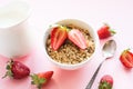 Healthy breakfast of granola, strawberry and milk on pink. Summer. Royalty Free Stock Photo