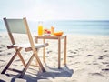 Healthy summer breakfast on seaside. Folding chair and wooden table on sand beach near sea water. Summer holiday or vacation Royalty Free Stock Photo