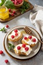 Healthy summer breakfast with sweet sandwiches with ricotta, raspberries and honey on a stone table