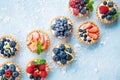 Healthy summer pastry dessert. Berry tartlets or cake with cream cheese top view.