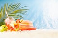 Healthy summer picnic on tropical beach with takeaway fresh food - fruit salad, cold strawberry cocktail, green apple, sun hat. Royalty Free Stock Photo