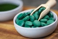 Healthy supplements - chlorella, spirulina algae powder and pills Royalty Free Stock Photo