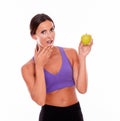 Healthy surprised brunette with an apple