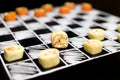 Playing chess with Japanese sushi roll pieces without rice on chalkboard background. Asian sushi with crunchy shrimp and avocado Royalty Free Stock Photo