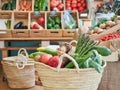Healthy and sustainable shopping concept. Wicker basket full of vegetables and fruits in a small local organic food store. Royalty Free Stock Photo