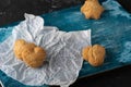 Healthy sweet cookies on a baking paper and blue wooden cutting board. Dark stone background Copy space. Close up Royalty Free Stock Photo