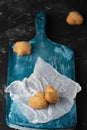 Healthy sweet cookies on a baking paper and blue wooden cutting board. Dark stone background Copy space. Close up Royalty Free Stock Photo