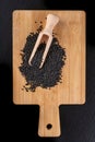 Healthy and tasty black cumin beans on a wooden board. Ingredients for a healthy diet in a modern kitchen Royalty Free Stock Photo