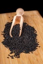 Healthy and tasty black cumin beans on a wooden board. Ingredients for a healthy diet in a modern kitchen