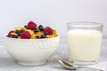 Healthy tasty breakfast: bowl with corn flakes and berries and glass of milk Royalty Free Stock Photo