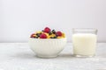 Healthy tasty breakfast: bowl with corn flakes and berries and glass of milk Royalty Free Stock Photo