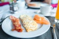 Healthy tasty american breakfast with omlette and bacon on table in cafe Royalty Free Stock Photo