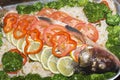 Healthy tasty homemade food. Fish appetizing vitamin dish with vegetables. Raw river carp stuffed with rice, fresh tomatoes, Royalty Free Stock Photo