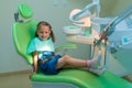 Healthy teeth patient girl waiting in dental chair in dentist of Royalty Free Stock Photo