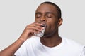 Healthy thirsty African American man drinking clean mineral water