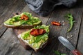 Healthy toast with avocado, goats cheese and arugula