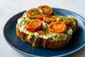 Healthy Toast Tartine with Cream Vegan Cashew Cheese Truffle Flavored, Pesto Sauce and Cherry Tomatoes Royalty Free Stock Photo