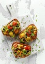 Healthy toasts with baked sweet cherry tomatoes and grilled zucchinin ribbons drizzled with balsamic vinegar