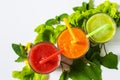 Healthy tomato, avocado and carrot smoothie in a glass on white background.